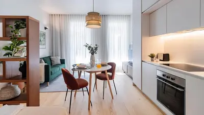 a kitchen and living room with a table and chairs at Almada 551 by LovelyStay in Porto