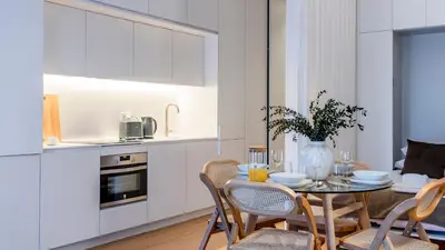 a kitchen and dining room with a table and chairs at Almada 551 by LovelyStay in Porto