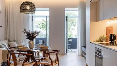 a kitchen and dining room with a table and chairs at Almada 551 by LovelyStay in Porto
