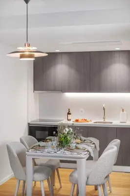 a kitchen with a white table and chairs at Sittium in Porto