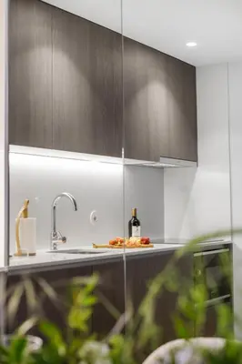 a kitchen with a sink and a bottle of wine at Sittium in Porto