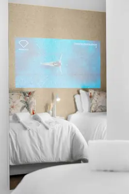 a bedroom with two beds and a bird in the water at Sittium in Porto