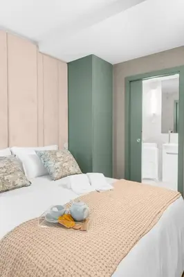 a white bed with a tray of food on it at Sittium in Porto