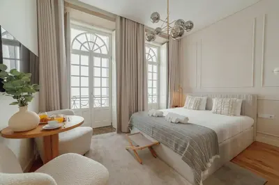a bedroom with a bed and a table and chairs at Clerigos Boutique Apartments by Hosty in Porto