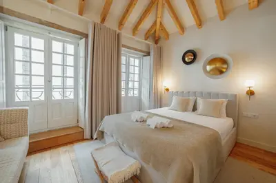 a bedroom with a large bed with two towels on it at Clerigos Boutique Apartments by Hosty in Porto
