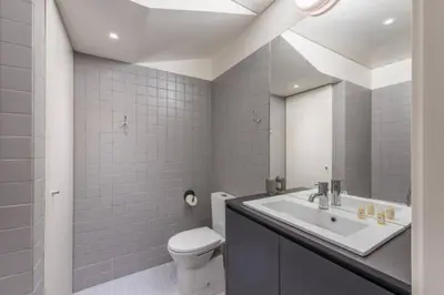 a bathroom with a sink and a toilet and a mirror at GuestReady - Genuine Residences in Porto