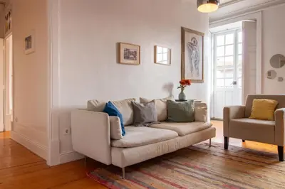 a living room with a couch and a chair at Porto 61 - Bright 2BR w/ Balcony by LovelyStay in Porto