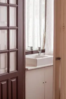 a bathroom with a sink and a mirror at Porto 61 - Bright 2BR w/ Balcony by LovelyStay in Porto