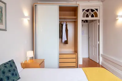 a bedroom with a bed and a dresser and a closet at Porto 61 - Bright 2BR w/ Balcony by LovelyStay in Porto