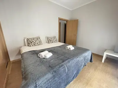 a bedroom with a bed with two towels on it at Moreda Garden Apartment by Trip2Portugal in Porto