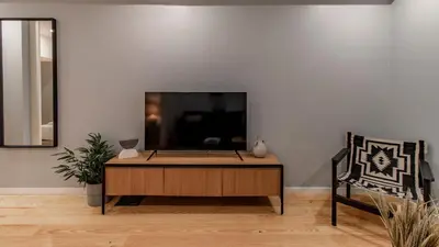 a flat screen tv sitting on top of a dresser at Belomonte 103 by LovelyStay in Porto