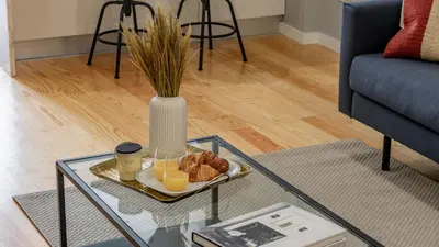 a glass table with a plate of food and a vase at Belomonte 103 by LovelyStay in Porto