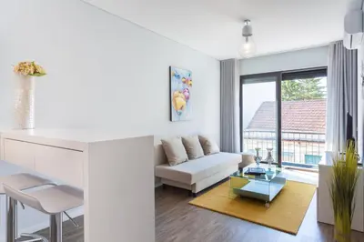 a living room with a couch and a table at Urban Views - ML Apart Inspired by Palácio de Cristal in Porto