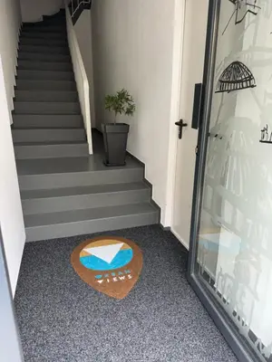 a stairwell with a rug on the floor next to a staircase at Urban Views - ML Apart Inspired by Palácio de Cristal in Porto