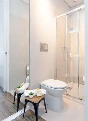 a white bathroom with a toilet and a shower at Urban Views - ML Apart Inspired in Serralves in Porto