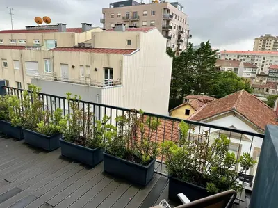 a balcony with pots of plants on a building at Urban Views - ML Apart Inspired in Serralves in Porto