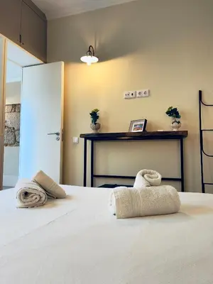 a bedroom with a bed with towels on it at Stylish Flat City Center in Porto