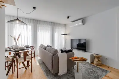 a living room with a couch and a table at João das Regras 321 by LovelyStay in Porto