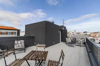 a balcony with benches and a view of a city at João das Regras 321 by LovelyStay in Porto