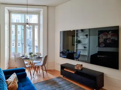 a bedroom with a large bed with two towels on it at Inspiring City Center 1 BR Apartment with a View in Porto