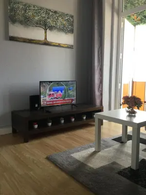 a living room with a tv and a table at Vicky Porto in Porto