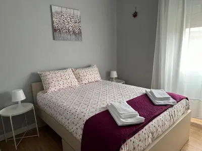 a bedroom with a bed with two towels on it at Vicky Porto in Porto