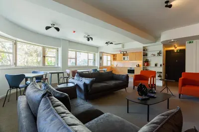a large living room with couches and a kitchen at Oporto City View - Guest House Suites in Porto