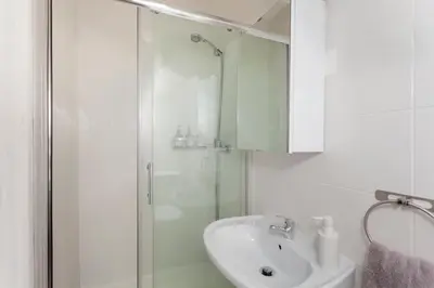a bed with two towels on it with two lights at Casa São Lourenço in Porto