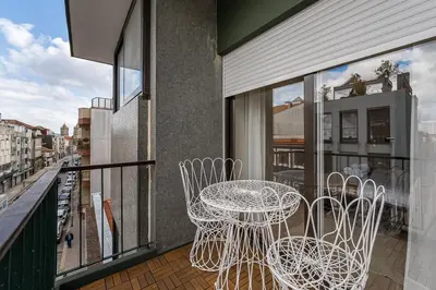 a balcony with a table and chairs on a balcony at GuestReady - Quental Wallpaper near Marquês Square in Porto