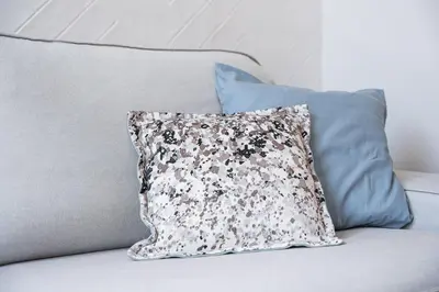 a pillow sitting on top of a couch at GuestReady - Quental Wallpaper near Marquês Square in Porto