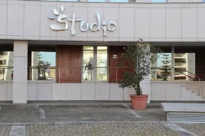 a room with chairs and a table and a window at Arrábida Luxury Studio in Vila Nova de Gaia