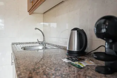 a kitchen counter with a sink and a phone at GuestReady - Portrait with a view in Porto