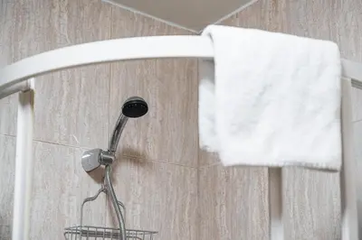 a shower head in a bathroom with a towel at GuestReady - Portrait with a view in Porto