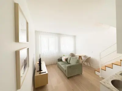 a living room with a couch and a table at Vibrant Host -Bonfim in Porto