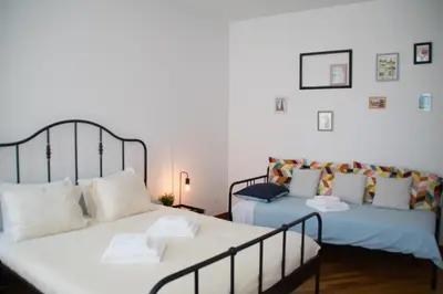 two beds sitting next to each other in a room at Goodgarden Downtown Apartment in Porto