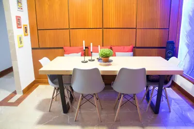 a table in a room with chairs around it at Goodgarden Downtown Apartment in Porto
