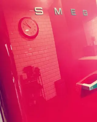 a red room with a clock on a wall at Goodgarden Downtown Apartment in Porto