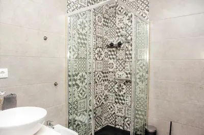 a bathroom with a shower with a glass door at Host Wise - Amadeo Apartments in Vila Nova de Gaia