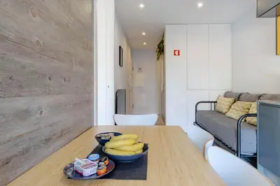 a kitchen with a wooden table with bananas on it at Host Wise - Amadeo Apartments in Vila Nova de Gaia