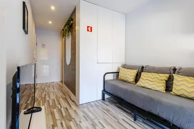 a living room with a couch and a hallway at Host Wise - Amadeo Apartments in Vila Nova de Gaia