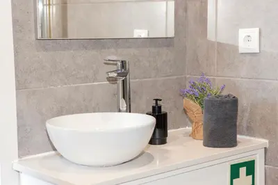 a bathroom with a white sink and a mirror at Host Wise - Amadeo Apartments in Vila Nova de Gaia