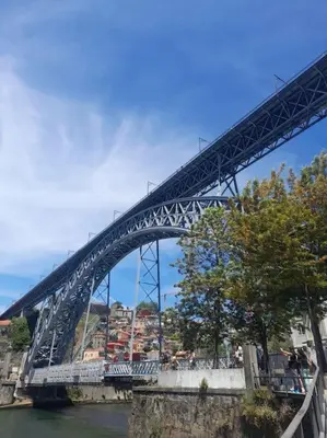 a bridge over a river with people on it at BEST View DOURO PORTO Penthouse in Vila Nova de Gaia