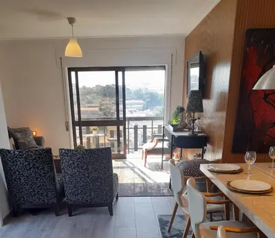 a living room with a table and chairs and a balcony at BEST View DOURO PORTO Penthouse in Vila Nova de Gaia