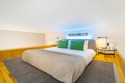 a bedroom with a large bed with green pillows at WHome Central 1-Bed w/ Top View perfect to Explore Porto in Porto