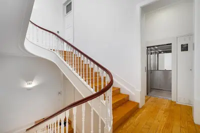 a staircase in a home with white walls and wood floors at WHome Central 1-Bed w/ Top View perfect to Explore Porto in Porto