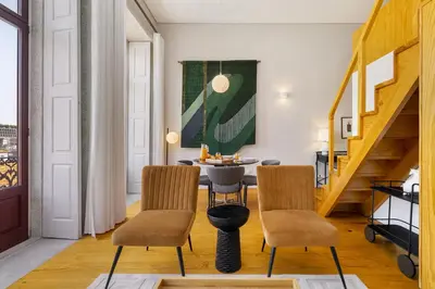 a dining room with stairs and a table and chairs at WHome Central 1-Bed w/ Top View perfect to Explore Porto in Porto