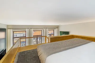 a bedroom with a bed and a balcony with windows at WHome Central 1-Bed w/ Top View perfect to Explore Porto in Porto