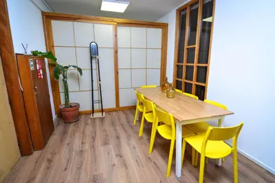 a dining room with a table and yellow chairs at Travel & Live Fernão Magalhães in Porto