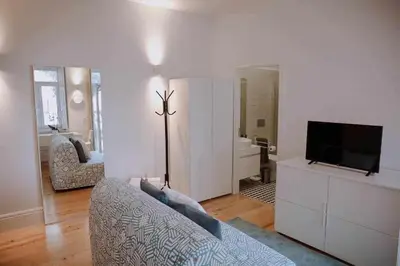 a living room with a couch and a flat screen tv at Porto Apartments in Porto