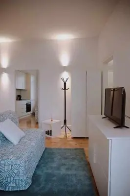 a living room with a bed and a television at Porto Apartments in Porto